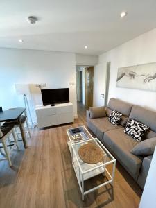 a living room with a couch and a table at Modern City Centre Two Bedroom Windsor Apartment - Grand Central House in Gibraltar