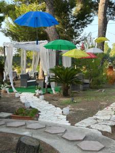 a group of umbrellas on a stone path at Villa Anna GuestHouse in Brindisi