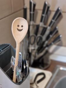 a wooden spoon with a smiley face in a sink at Ana Studio in Hunedoara