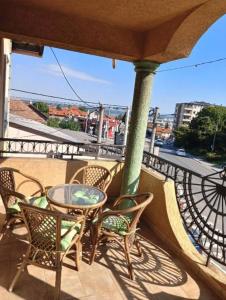 a patio with chairs and a table on a balcony at Car Konaci in Smederevo