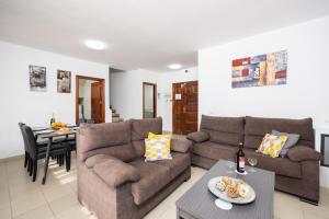 a living room with a couch and a table at Villa Alexsandra in Playa Blanca