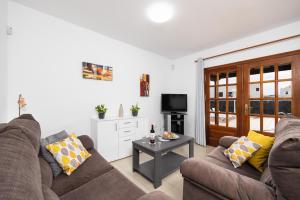 a living room with two couches and a table at Villa Alexsandra in Playa Blanca
