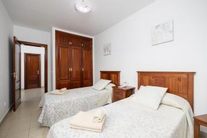 a room with two beds with towels on them at Villa Alexsandra in Playa Blanca +21 photos