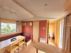 a small room with a table and a bench at Camping les 2 salamandres in Arces-sur-Gironde
