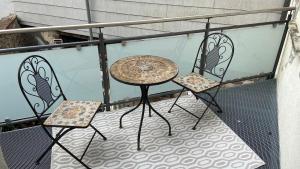 a table and two chairs on a balcony at Ferien am Schlössle in Ochsenfurt