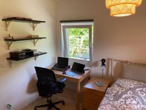 a bedroom with a desk with two laptops on it at Ruheoase unweit von Berlin in Königs Wusterhausen