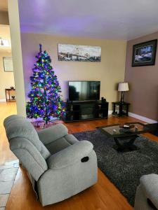 una sala de estar con un árbol de Navidad y un sofá en Réveillez-vous, en Repentigny