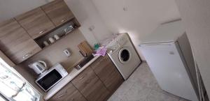 a kitchen with a washing machine and a refrigerator at BeLApartment in Petrich +9 photos