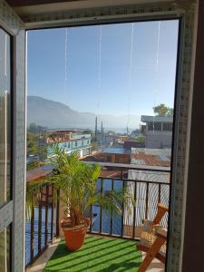 a balcony with a view of a city at Casa Chikuwa in San Juan La Laguna