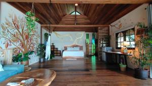 a large room with a bed and a couch at Why Nam Beach in Haad Yuan