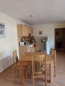 a kitchen and dining room with a wooden table and chairs at Magical apartment in Marina view Fort beach in Sveti Vlas