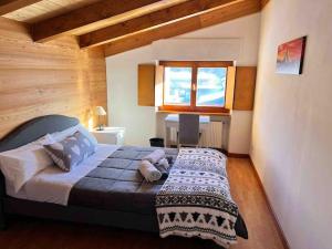 a bedroom with a bed in a room with a window at Cozy Penthouse 2 bedrooms with WiFi - Netflix - Private Parking in Tarvisio