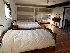 a bedroom with two beds and a room with twounks at Estancia TATAY in Trelew