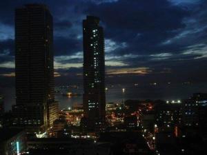 a city skyline at night with a tall building at 1BR Condo Unit W/ Fantastic View near US Embassy in Manila