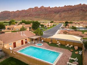 an aerial view of a home with a pool and mountains at Rim Village I1 in Moab