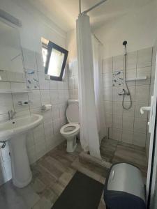 a bathroom with a toilet and a sink and a shower at CASA SMARALD in Costinesti