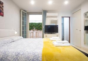 a bedroom with a large bed and a tv at Casa Orchidea - The Fab Stay in Brindisi