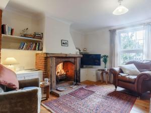 a living room with a fireplace and a couch at 2 Bed in Winterton-on-Sea 85872 in Winterton-on-Sea