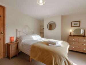 a bedroom with two beds and a mirror at 2 Bed in Winterton-on-Sea 85872 in Winterton-on-Sea