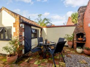 a patio with a table and chairs on a patio at 2 Bed in Winterton-on-Sea 85872 in Winterton-on-Sea