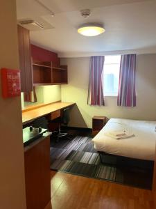 a hotel room with a bed and a desk at For Student Only City Living Studios in the heart of Coventry at Market Way in Coventry