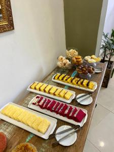 a table with several plates of food on it at Pousada Casa Imperatriz - Rua Teresa in Petrópolis