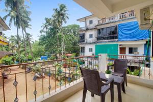 a balcony with chairs and a view of a playground at OYO 92630 Bharat Holiday Home in Saligao
