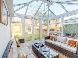 a conservatory with a couch and a glass ceiling at 3 Bed in Rowlands Gill 86802 in Stanley