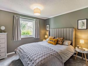 a bedroom with a large bed and a window at 2 Bed in Keswick 87092 in Keswick