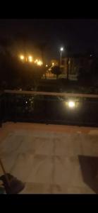 a view of a street at night with lights at 2 bedroom cozy aprt in ‘Ezbet `Abd el-Ḥamîd