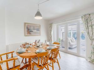 a dining room with a wooden table and chairs at 3 Bed in Seahouses 86834 in North Sunderland