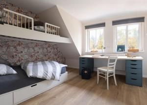 a bedroom with a bed and a desk and a bed and a desk at Ferienwohnungen in Wald und Flur - Wohnung Wald in Lüder