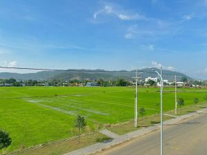 a field of green grass with a street light at Ruby Motel Bà Rịa in Ba Ria