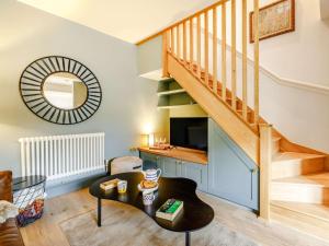 a living room with a staircase and a table at 1 Bed in Charmouth 87528 in Charmouth
