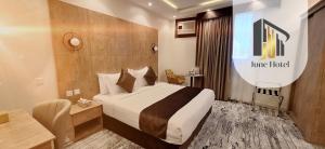 a hotel room with a large bed and a desk at فندق جون in Abha