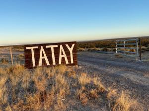 a sign that says taxi in the middle of a field at Estancia TATAY in Trelew