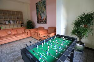 a living room with a table with a soccer game on it at Yangshuo Xiao Long River Hotel in Yangshuo