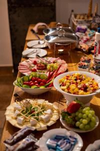 una tavola con piatti di alimenti e ciotole di ortaggi di Pension Adalbert a Cesky Krumlov