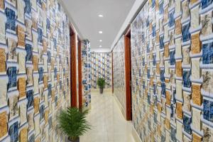 a hallway with blue and white tiles on the wall at SPOT ON Lewis Paradise in Bhubaneshwar