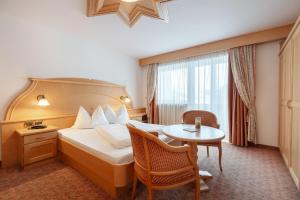 Postel nebo postele na pokoji v ubytování Piccolo Hotel