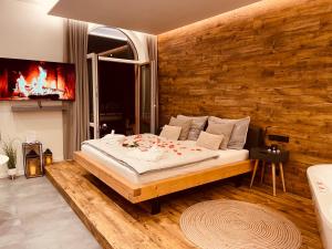a bedroom with a large bed and a tv at Golden Key Apartments in Liberec