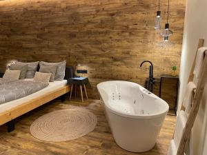 un bagno con vasca accanto a un letto di Golden Key Apartments a Liberec