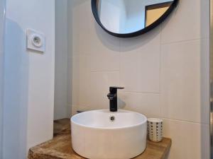 a bathroom with a white sink and a mirror at Appartement cœur de Doutre in Angers