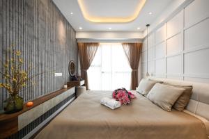 a bedroom with a large bed with flowers on it at Royal State - The Ascentia Phu My Hung in Ho Chi Minh City