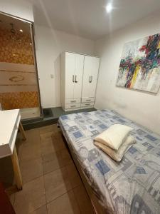 a bedroom with a bed and a bathroom with a sink at Aparta Hotel in Buenos Aires