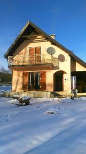 een huis met een balkon in de sneeuw bij Vikendica Cican Jahorina in Jahorina