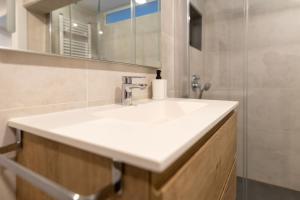 a bathroom with a white sink and a shower at Suitur Apartamento Roc Sant Gaietà I in Roda de Bará +43 photos