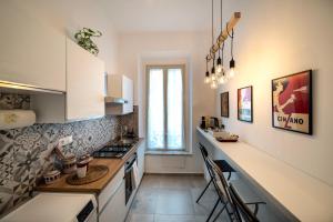 a kitchen with white cabinets and a counter top at La casa del Conte in Messina