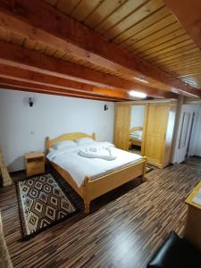 ein Schlafzimmer mit einem großen Bett in einem Zimmer in der Unterkunft Cabana Daianna si Jessica in Poiana Vadului