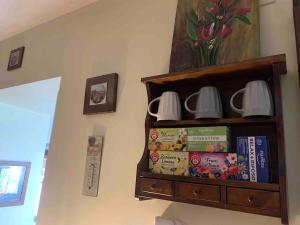 a book shelf with cups and books on it at Casa Aurora in San Potito